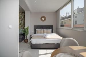 A bed or beds in a room at Heart Of Athens Apartments