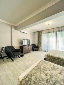 Телевизор и/или развлекательный центр в Ida Hotel