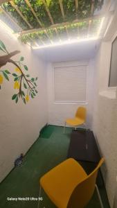 a room with a yellow chair and a table at Vinaros Mar de Plata in Vinarós