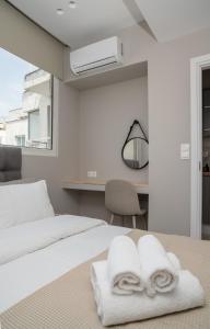 A bed or beds in a room at Heart Of Athens Apartments