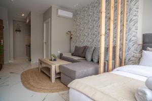A bed or beds in a room at Heart Of Athens Apartments