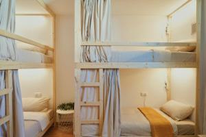 two bunk beds in a room with two beds at Blue Surf House in Corralejo