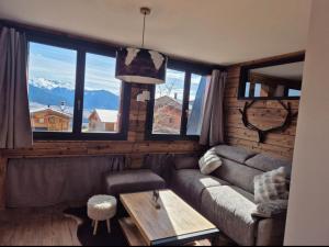 a living room with a couch and a table at 'Le Bellevue' coté Montagne BY P&T in Font-Romeu
