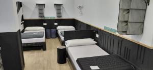 a room with a row of beds in a room at Albergue A ROTONDA in Redondela