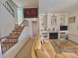 a living room with a couch and a fireplace at Villa Mediterranea Tossa in Tossa de Mar +44 photos