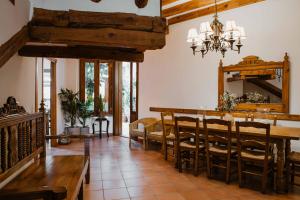 a dining room with a wooden table and chairs at La Casona de Mahora in Mahora