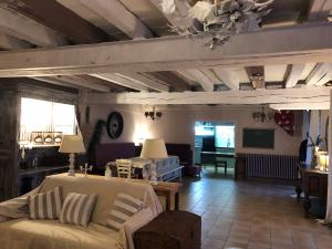 a living room with a couch and a table at Gite chez mary au domaine du château de ragny in Savigny-en-Terre-Plaine