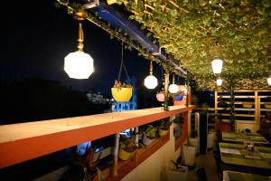 a bar with pendant lights and potted plants at Hotel Buddha International in Patna