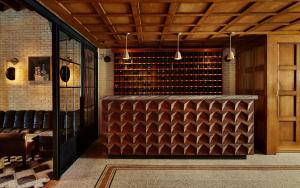 a bar in a restaurant with a brick wall at The Ludlow Hotel in New York