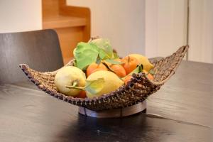 a basket of fruits and vegetables on a table at AnticaFirenze in Florence