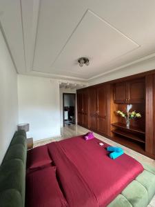 a large couch in a living room with a red blanket at Daijobu in Tangier Relax in Exclusive Pool in Tangier +17 photos