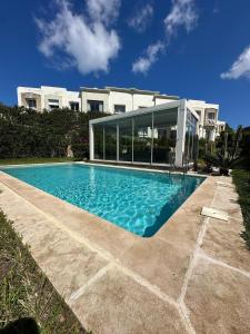 a swimming pool in front of a house at Daijobu in Tangier Relax in Exclusive Pool in Tangier
