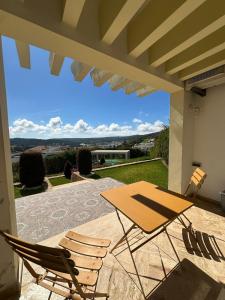 a table and two chairs sitting on a patio at Daijobu in Tangier Relax in Exclusive Pool in Tangier