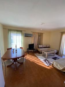 a living room with a table and a couch at Oasis Paralio Astros in Paralio Astros