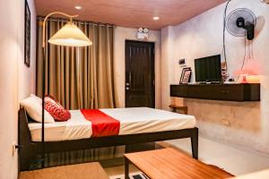 a small room with a bed and a desk at DMall Central Stn 2 Near Beach in Boracay