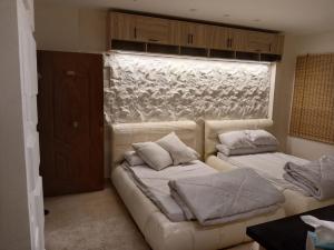 a living room with two beds and a window at الجناح الملكي بالعالمين شامله الأكوا بارك مجانا in El Alamein