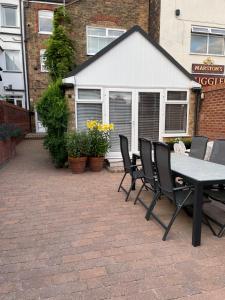 a picnic table and chairs on a brick patio at The Tides in Cleethorpes