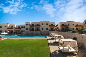 a resort with a swimming pool and some buildings at Kambos Village in Agia Marina Nea Kydonias