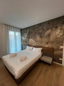 Postel nebo postele na pokoji v ubytování Jesolo Fronte Mare Pineta - Jl Blue Apartments C7