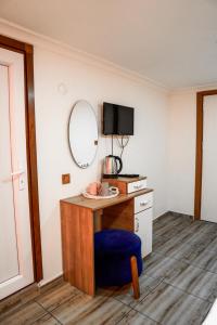 a room with a desk with a blue chair and a mirror at LAOS OTEL in Istanbul +64 photos