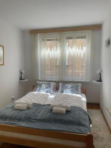 a bedroom with a large bed with two pillows at Apartment RENA - private parking in Sarajevo