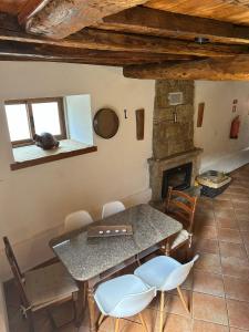 a dining room with a table and a fireplace at Casa da Cantarinha in Fundão +7 photos