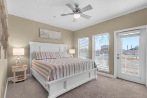 a bedroom with a bed and a ceiling fan at House of the Blues in Pensacola Beach