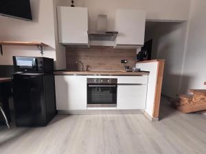 a kitchen with a sink and a stove top oven at Valley View Studio in Saint Vincent