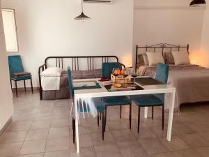 a bedroom with a bed and a table and chairs at Case Vacanze - da Francesco in Policoro