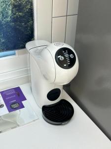 a hair dryer sitting on a counter in a bathroom at Momo House in Gimhae
