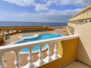 a view of the pool from the balcony of a cruise ship at Arenas Blancas 203 in La Restinga