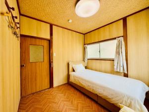 Postel nebo postele na pokoji v ubytování 昭和乃風 Showa No Kaze