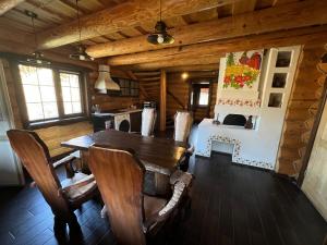 a dining room with a wooden table and chairs at Gostynna sadyba Kit Bayun in Teterivka