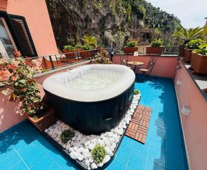 a bath tub on the roof of a building with a pool at La Maison Rose in Maiori