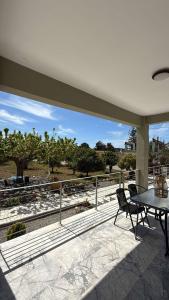 a patio with a table and a table and chairs at Εξοχικό elia lakonias in Elia Laconias