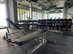 a gym with rows of exercise equipment in a room at Bellevue lagoon 20 units in Laguna Phuket