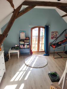 a attic room with a room with a ceiling with beams at maison 3 chambres 24h le mans in Le Mans