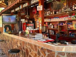 a bar in a restaurant with a tv on the counter at Парк-хотел Родопи in Churen