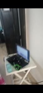 a laptop computer sitting on a white table at Dar lbahia in Oulad Akkou