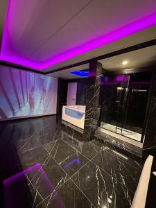 a bathroom with a tub and purple lighting at Gladiatrice Suite in Rome +13 photos
