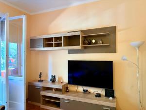 a living room with a flat screen tv on a wall at Center Square in Podgorica +6 photos