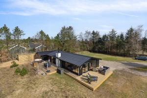 an overhead view of a house with a black roof at Cozy Summer House In North Jutland in Jerup