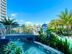 a bridge over a pool at a water park at The Sóng Apartment Vũng Tàu - Căn Hộ Hồ Bơi-Olive Homestay in Vung Tau