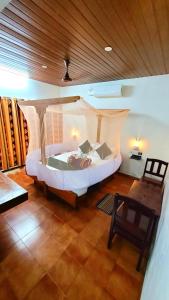 a bedroom with a large bed in a room at Kottaram Heritage Resort in Alleppey