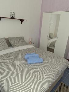 a bedroom with a bed with two towels on it at Room Nena in Senj