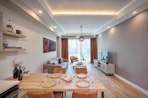 a living room with a table with chairs and a couch at Sirius Town Residence and Spa in Antalya