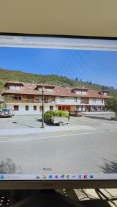 a computer monitor with a view of a building at Apartamento Picos de Europa in Camaleño