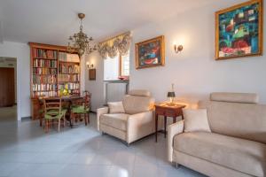 a living room with a couch and chairs and a table at Torre Cangiani in Massa Lubrense