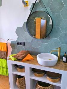 a bathroom with a sink and a mirror on a counter at Casa LaLa in El Roque