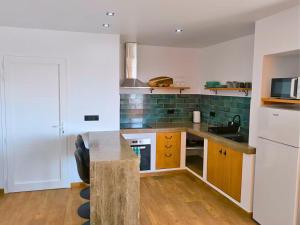a kitchen with a counter and a sink and a refrigerator at Casa LaLa in El Roque +5 photos